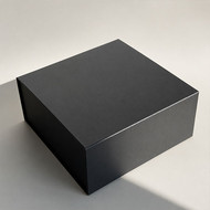 Boîte cadeau carrée noire fermée, vue de trois quarts